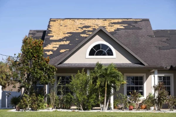 residential house with roof wind damage