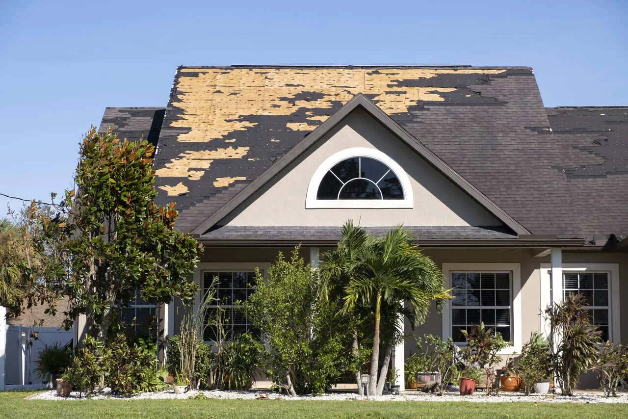 residential house with roof wind damage
